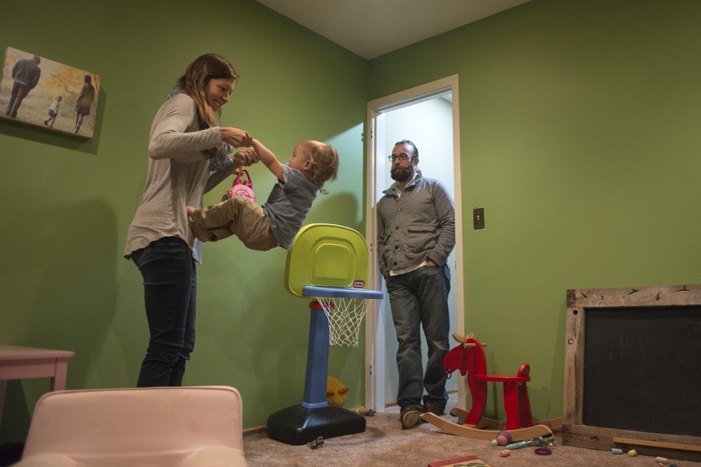 Annabelle Stalboerger and Edward Teddy Fleming play with their 18-month-old son E.J. on Thursday, Sept. 15, 2016 at their home in Sartell, MN. University of Minnesota third year law student Edward Teddy Fleming had testified in March to help a bill pass to modify child care grant eligibility to include graduate students. They spend about $18,000 per year on child care expenses. 