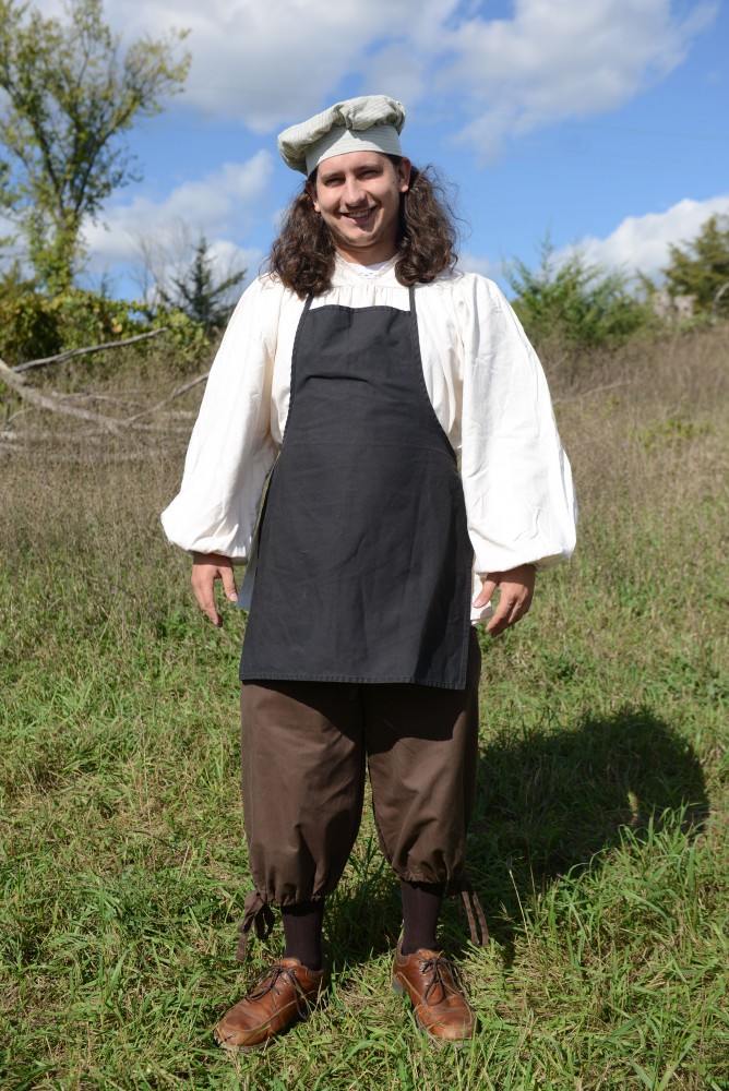 Alex Stanishevskay poses outside of the Minnesota Renaissance Festival in a peasant outfit featuring a bakers hat and apron on Sept. 17, 2016. 