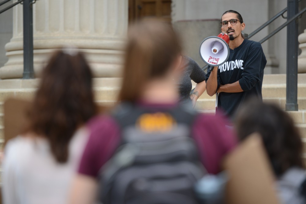 Sociology graduate student Rahsaan Mahadeo speaks to protesters on Friday, Sept. 23, 2016 at Northrop Plaza. Student coalition Differences Organized gathered to protest the treatment of contingent faculty.