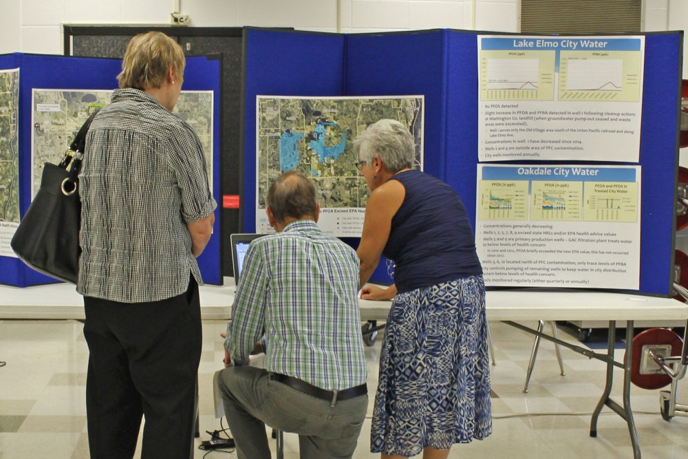 Hydrogeologist for the Minnesota Department of Health Virginia Yingling, right, explains data on local water to visitors at a public meeting at Oakland Middle School on Sept. 19 2016.  