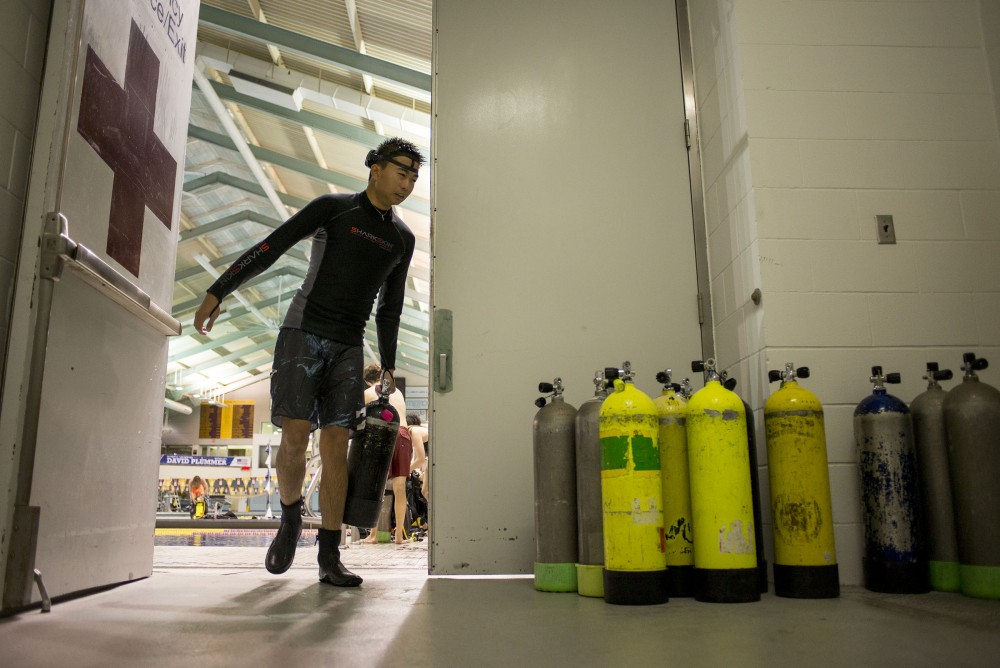 Nathan Wong returns his air tank after diving to a equipment room on Sept. 21, 2016, at the University Aquatic Center.