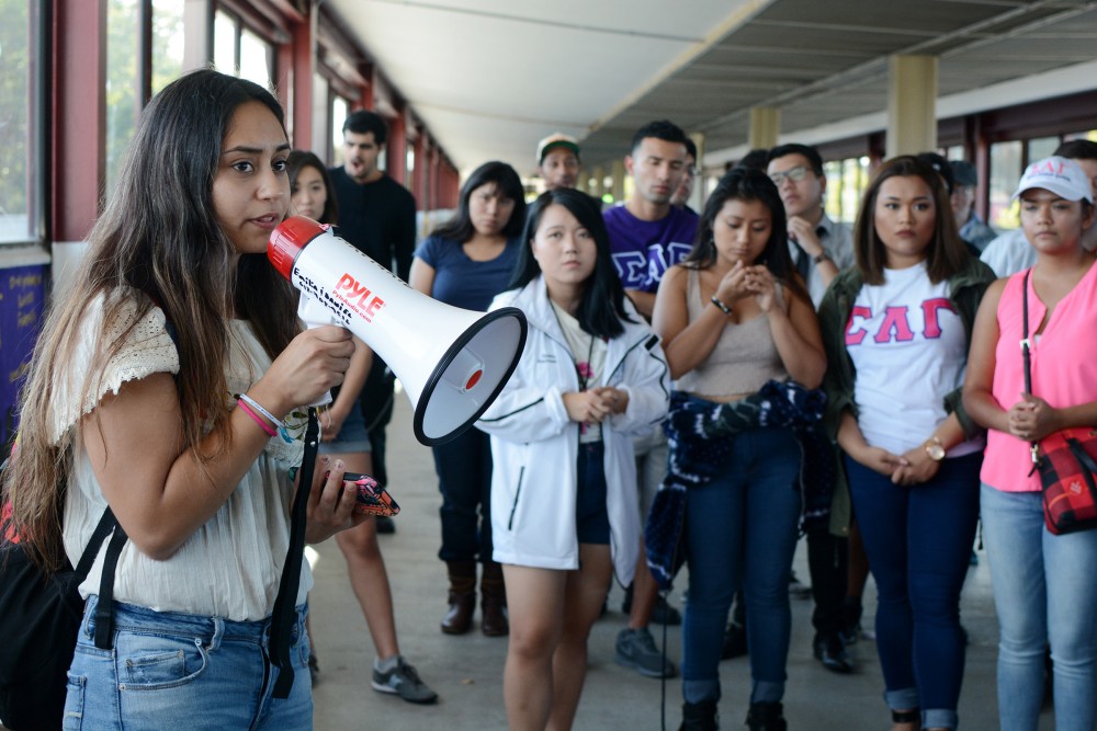 Psychology sophomore Melody Colón speaks during a protest on the Washington Avenue Bridge on Saturday, Sept. 30, 2016. During the Paint the Bridge event, College Republicans at the University of Minnesota painted a panel with a Donald Trump slogan that angered students. 