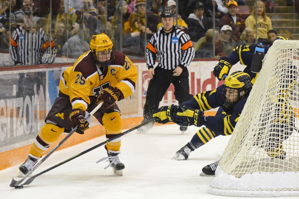 Gophers forward Justin Kloos controls the puck while playing against Michigan in Mariucci Arena on Feb. 26, 2016. 