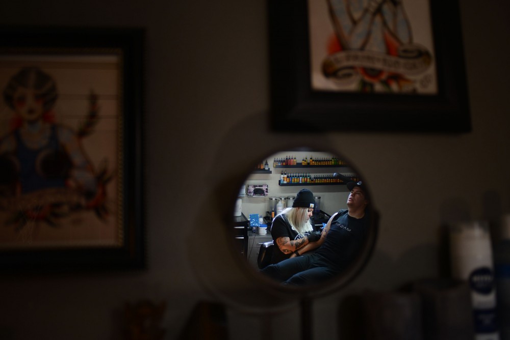 Shop owner and tattoo artist Nikki Time works on client Dan Wades tattoo at MPLS Tattoo Shop on Friday, Sept. 30, 2016 in Minneapolis.