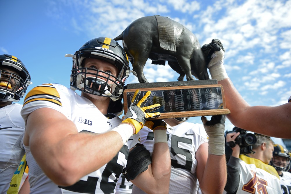 The Hawkeyes celebrate their win over the Gophers, carrying the Floyd of Rosedale rivalry trophy across the field on Oct. 8, 2016 at TCF Bank Stadium.