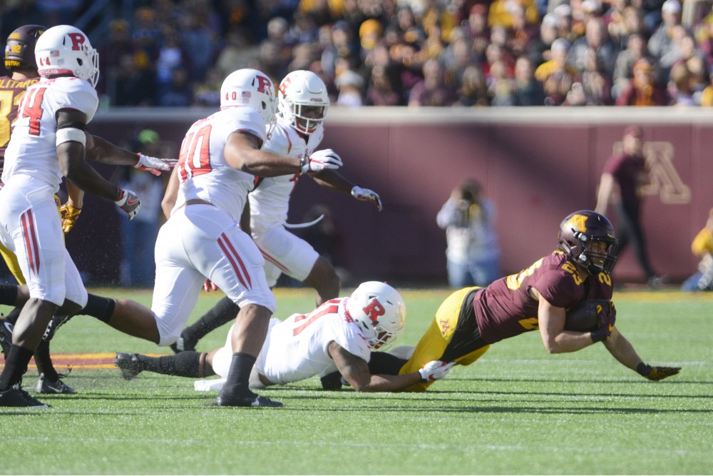 Gophers running back Shannon Brooks is tugged down on Saturday, Oct. 22, 2016 at TCF Bank Stadium.
