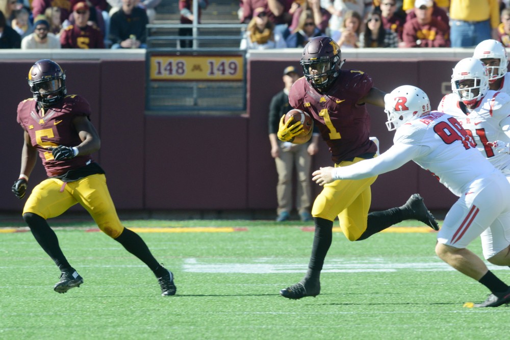 Running back Rodney Smith runs the ball up the field on Saturday, Oct. 22, 2016 at TCF Bank Stadium. The Gophers played against Rutgers University Scarlet Knights at the Gophers Homecoming game.