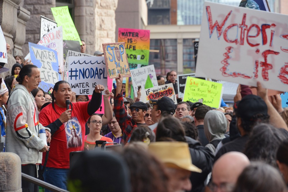 Protesters gather outside Minneapolis City Hall on Friday Oct. 28, 2016. Protesters rallied to show their opposition to the Dakota Access Pipeline and the Hennepin County Sheriffs deputies participation in dispersing protesters.
