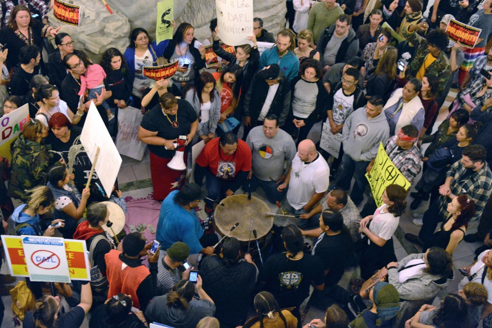 Protesters beat a drum on Friday Oct. 28, 2016 inside Minneapolis City Hall. Protestors rallied together to show their opposition to the Dakota Access Pipeline and the Hennepin County Sheriffs deputies participation in dispersing protesters.