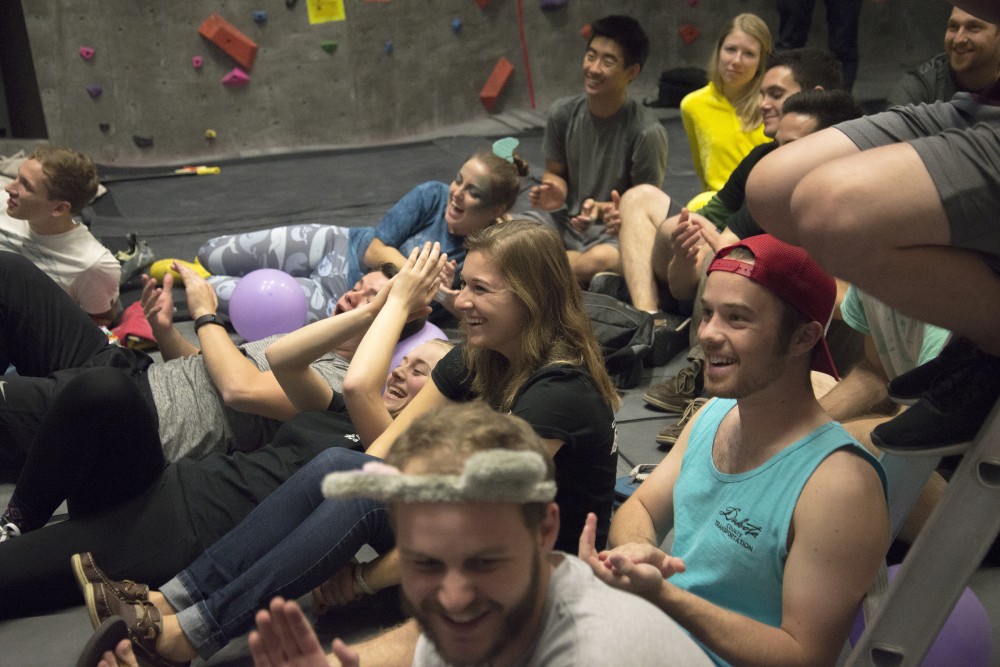 Climbers cheer on during the last seconds of climbing on Saturday, Oct. 29, 2016 at the University Recreation and Wellness Center Climbing Gym.