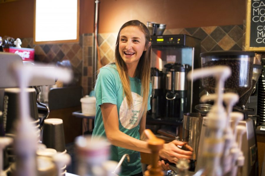 Senior Jordan Pinneke engages with a customer while preparing a coffee drink at Espresso Expose, where she works, on Saturday, Jan. 30. Pinneke works a number of jobs to help pay for school, a busy lifestyle which also helps her cope with her mental illness.