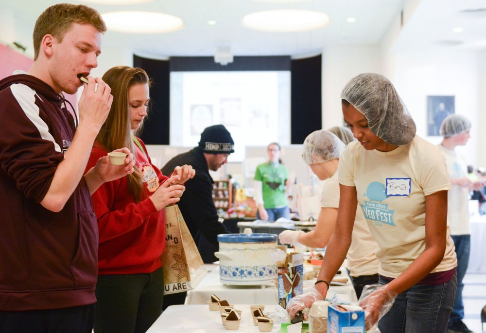 Freshmen pre-architecture majors Nathan Manske and Lanie Hei taste free samples of non-dairy soy ice cream sandwiches on at the Twin Cities Veg Fest on October 26, 2013 at Coffman Union. 