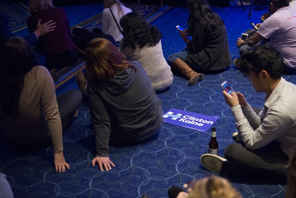 Attendees sit on the ground as they watch election results roll in at the Minnesota DFL election night party at the Minneapolis Hilton on Tuesday, Nov. 8, 2016.