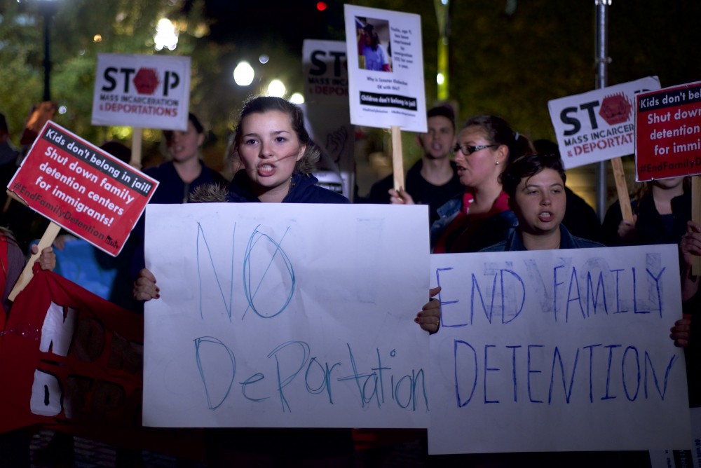 Amelia Gerrard holds a sign saying No Deportation outside the McNamara Alumni Center on Thursday, Nov. 10, 2016.