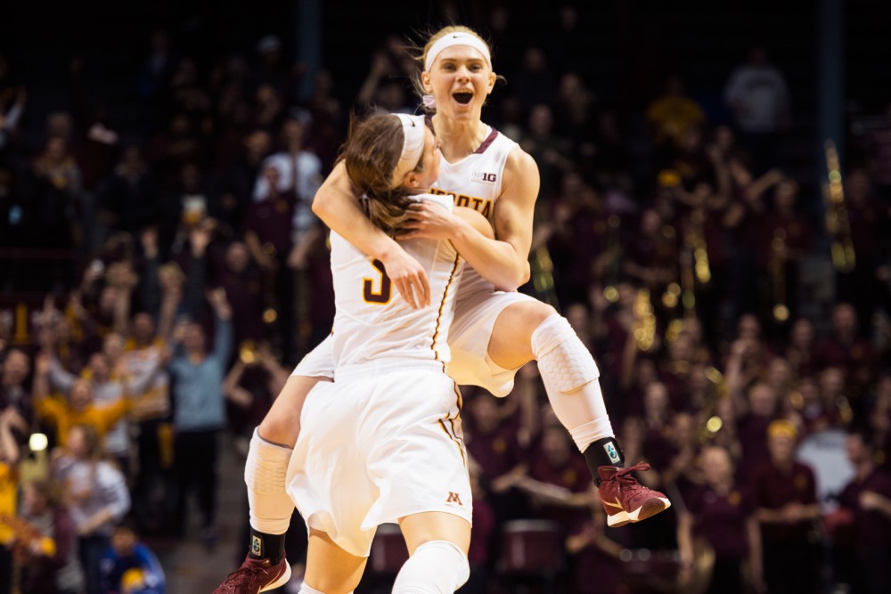 Sophomore guard Carlie Wagner jumps into the arms of teammate Shayne Mullaney after her game-winning shot in overtime against Ohio State in Williams Arena on Wednesday night.
