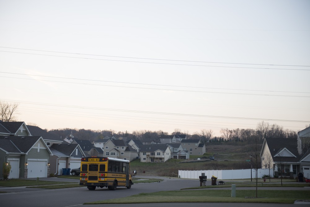 The school bus departs Marian Ahmeds house with Anas inside on Monday, Nov. 14, 2016 outside their home in Savage, Minnesota. Marian walks inside ready to wake the remaining children up for school.