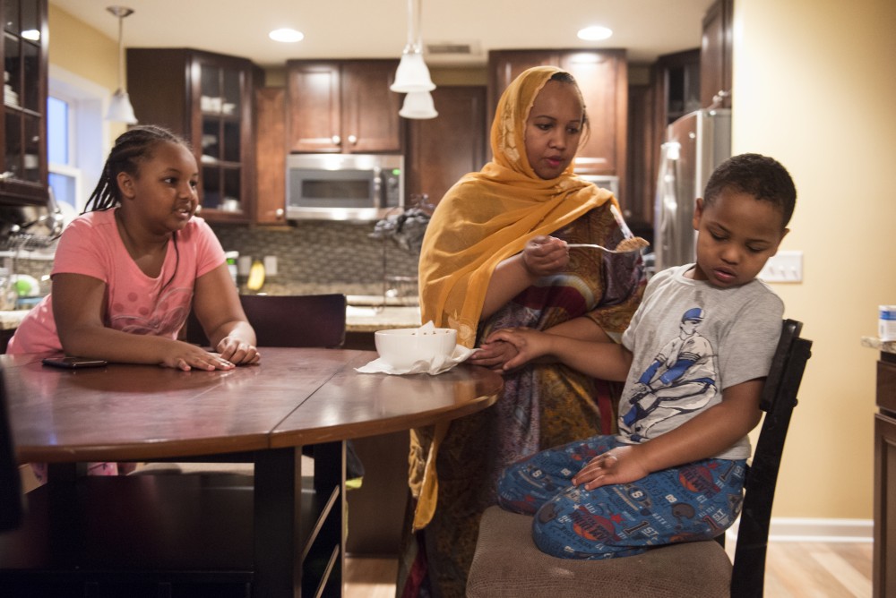 Marian Ahmed attempts to feed her son, Anas, a breakfast of warmed cereal as Aslaa watches on Monday, Nov. 14, 2016 at their home in Savage, Minnesota.