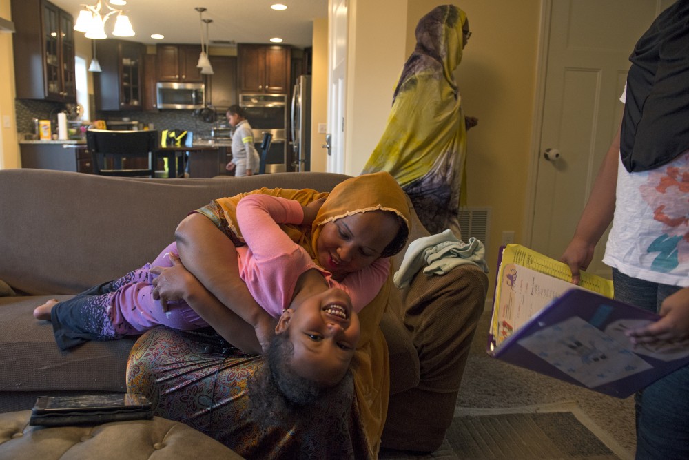 Marian Ahmed plays with her daughter Edna while Aslaa waits for her agenda to be signed moments before they leave for school on Monday, Nov. 14, 2016 at their home in Savage, Minnesota.