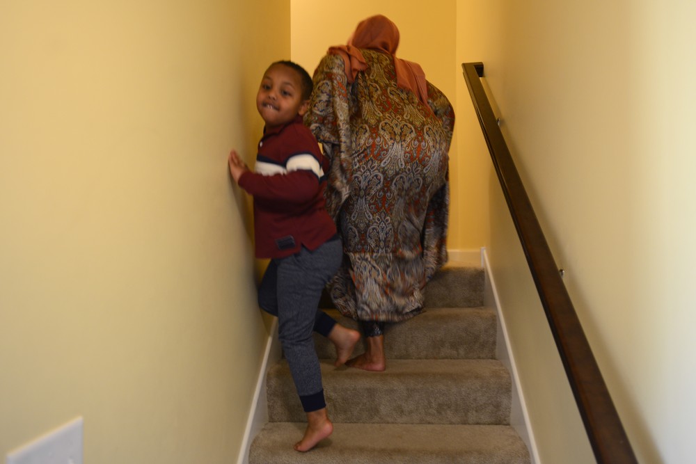 Marian Ahmed guides her son Anas up the stairs on Sunday, Nov. 6, 2016 at their home in Savage, Minnesota. Anas, 6, struggles with the severity of his autism and must be constantly kept in sight.