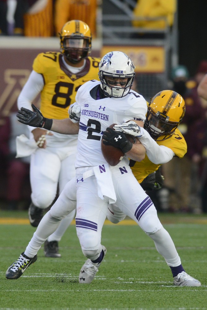 Sophomore wide receiver Flynn Nagel is tackled by sophomore defensive back Kiante Hardin at TCF Bank Stadium on Saturday, Nov. 19, 2016. The Gophers would win 29-12 against Northwestern University.