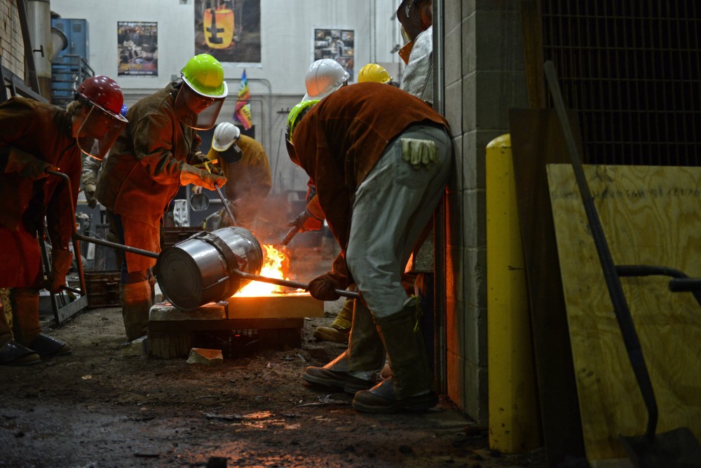 Participants in the 30th annual Iron Pour work in the foundry at the Regis Center for Art on Nov. 18, 2016.