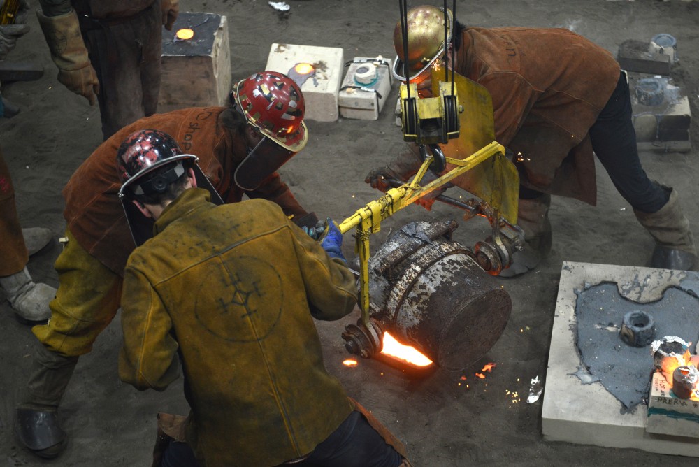 Participants in the 30th annual Iron Pour work in the foundry at the Regis Center for Art on Nov. 18, 2016.