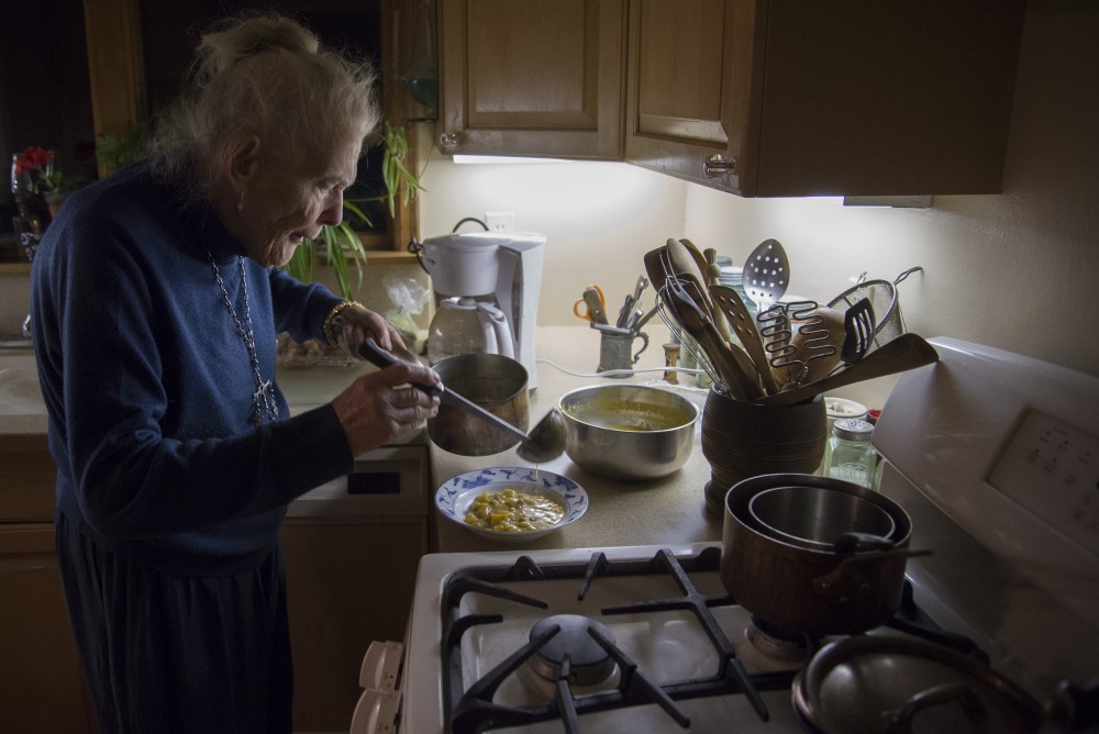 Mary Alice Kopf prepares soup for a guest at her home in Minneapolis on Saturday, Nov. 19, 2016.
