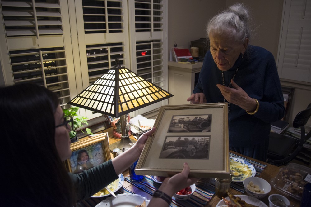 Mary Alice Kopf, right, shares a photo of her dad and brothers with Julia Turnbow over dinner at Marys home in Minneapolis on Saturday, Nov. 19, 2016.