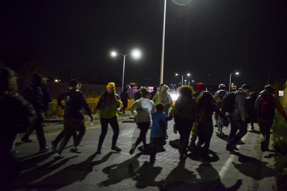 Protesters run toward the on-ramp to I-94 on Thursday, Nov. 10, 2016. Protesters shut down I-94 in response to Donald Trumps election.