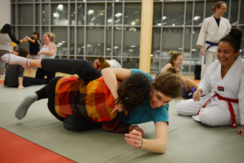 Students Sara Jalil and Rebecca Goldblum practice overpowering an aggressor at a womens self defense seminar at the Recreation and Wellness Center on Nov. 30, 2016. 