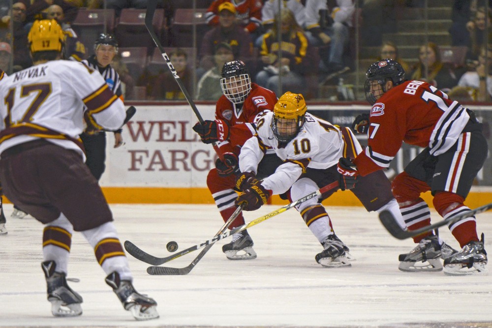 Gophers forward Brent Gates Jr. battles for the puck against St. Cloud State at Mariucci Arena on Oct. 21, 2016. 