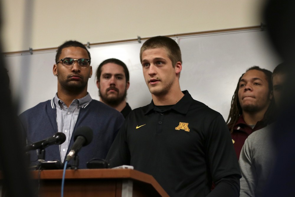 Senior wide receiver Drew Wolitarsky, right, addresses reporters at a news conference, announcing the end of the Gophers football teams boycott on Saturday, Dec. 17, 2016. The team boycotted after 10 players were suspended in relation to a Sept. 2 alleged sexual assault.