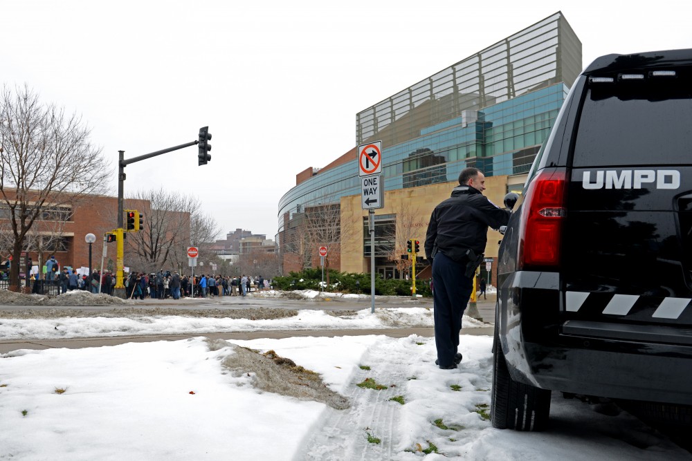 UMPD Officers watch as the crowd of protesters grows outside the Humphrey School of Public Affairs on Friday, Jan. 20, 2017. 