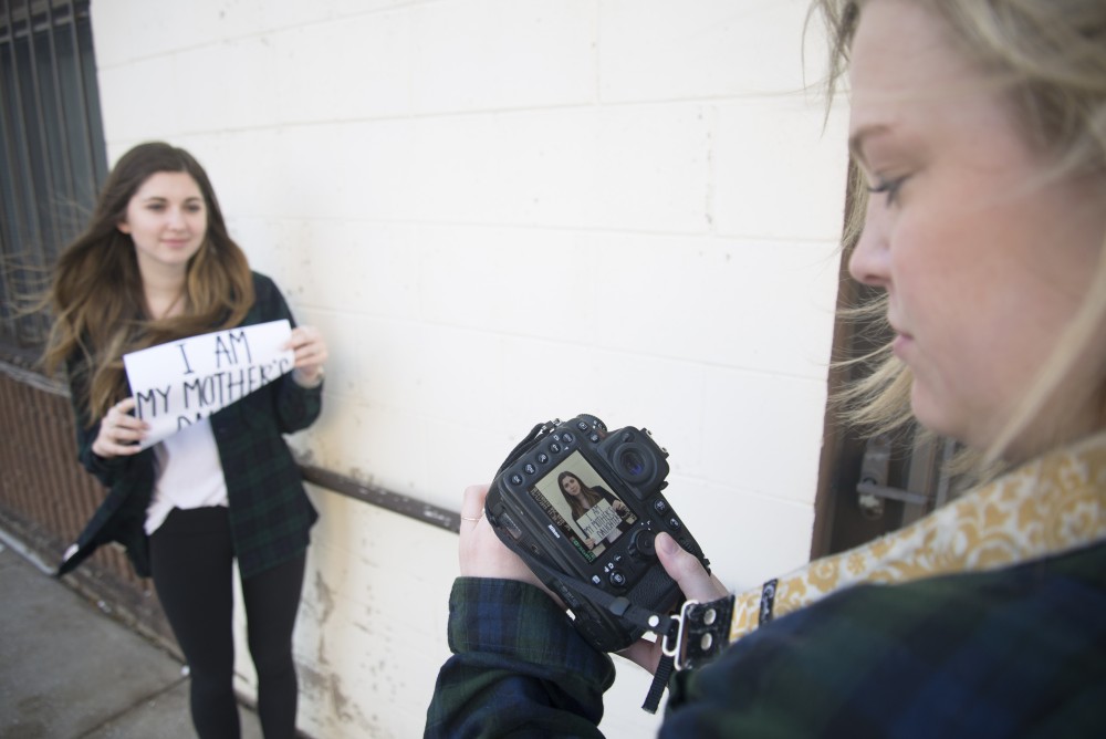 Ali Miller takes a photo of Sami Young holding her story on Friday, Jan. 27, 2017 outside her apartment in Minneapolis.