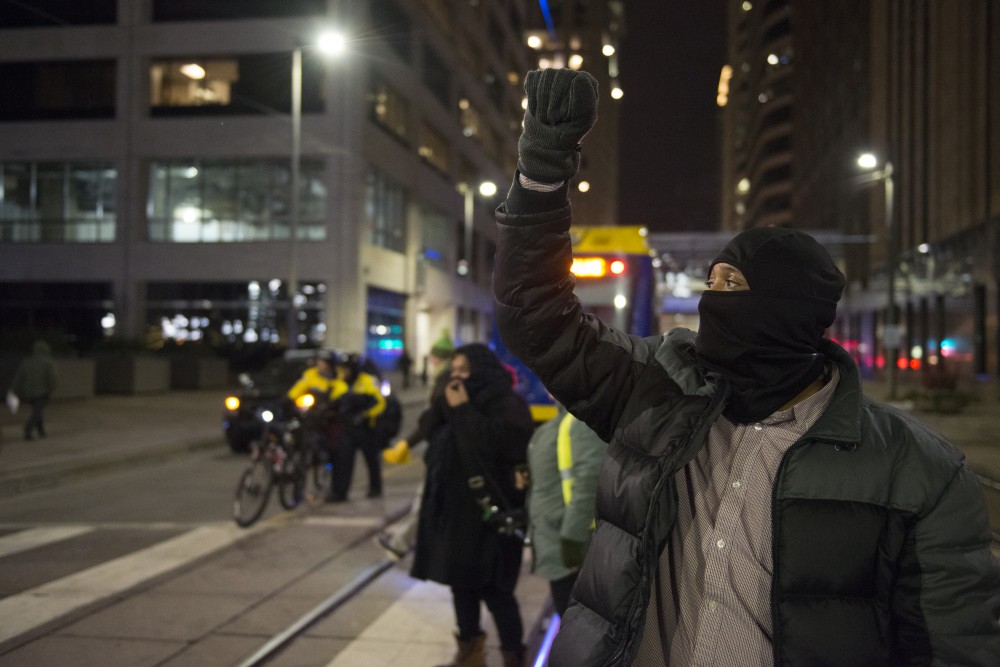 Dennis Cherry Sr. stands in-front of the light rail in during a protest of President Donald Trumps immigration policies in Minneapolis on Tuesday, Jan. 31, 2017. We already know whats gonna happen, Cherry said. 