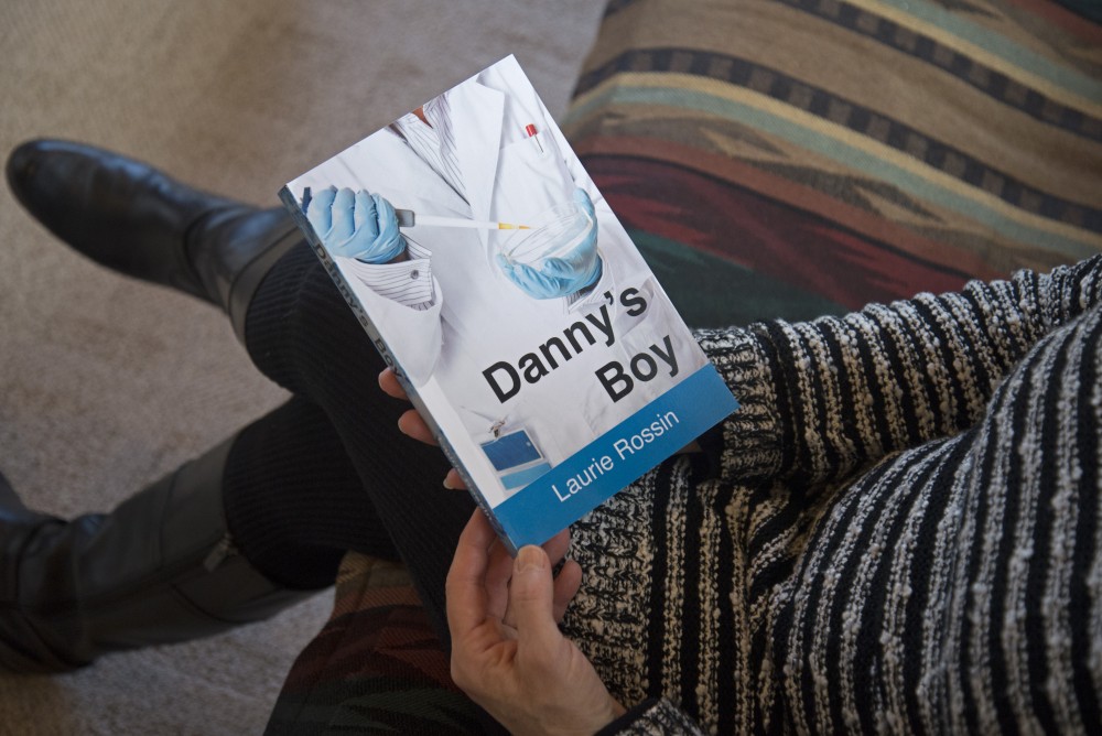 Laurie Rossin holds a copy of her book Dannys Boy a novel set at the U of M stem cell research center. 