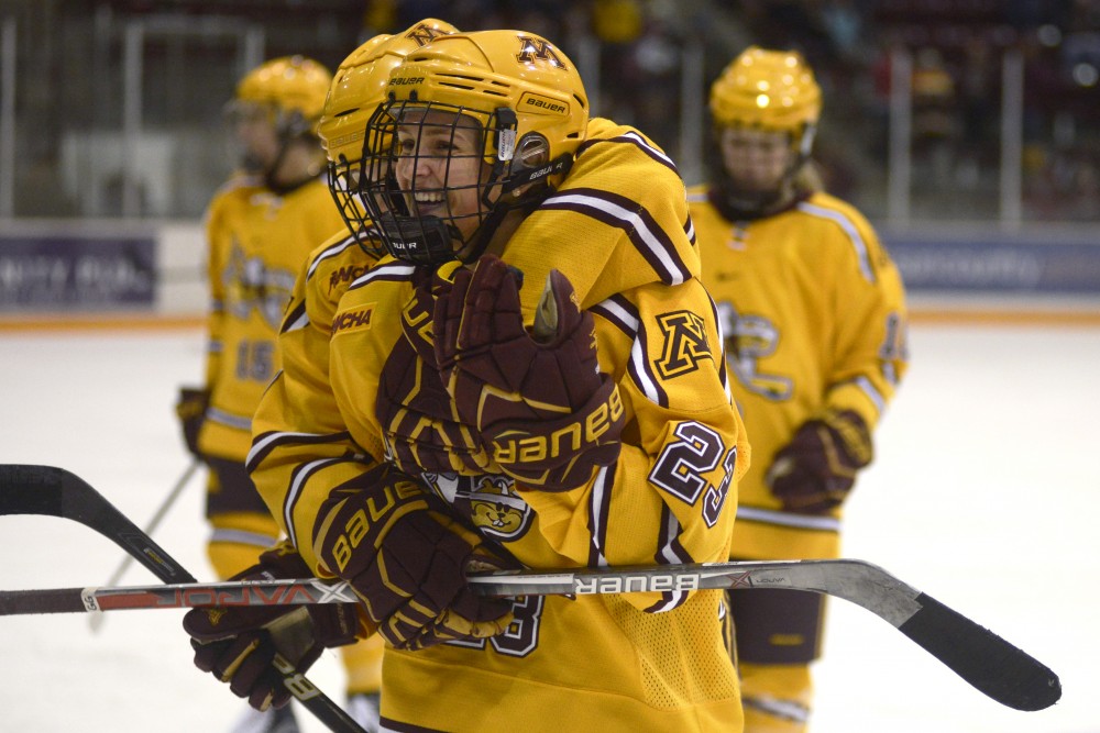 Junior forward Caitlin Reilly celebrates with teammates after scoring her second goal of the game on Saturday at Ridder Arena in Minneapolis. The Gophers won 6 - 2 against UND.