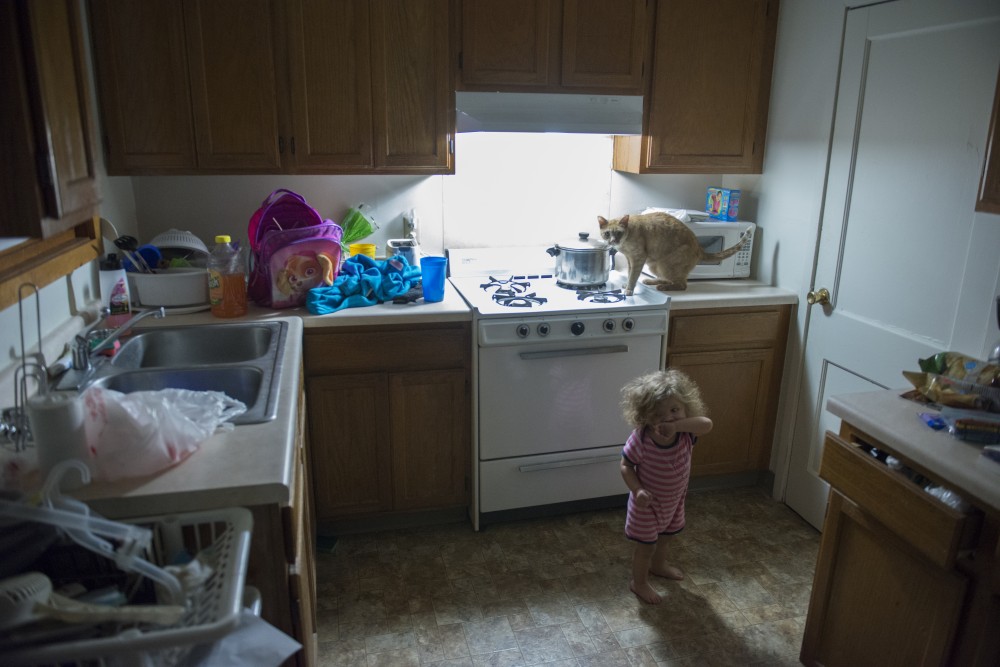 Nearly two-year-old Charlotte stands in the kitchen of her familys apartment in the Glendale Community Townhomes on Friday, Feb. 3, 2017.