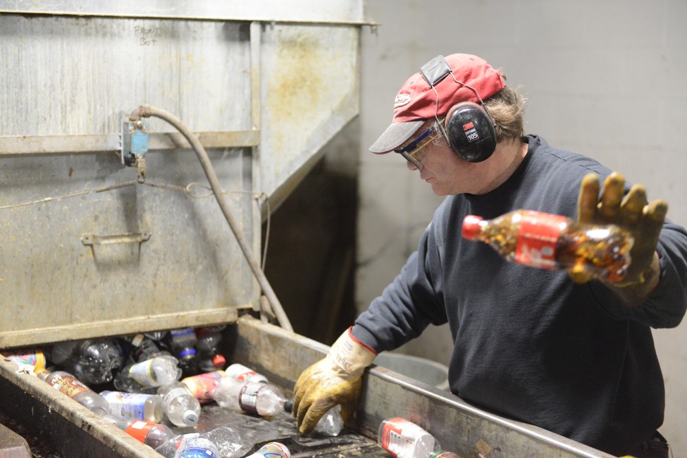 Utility worker Jeff Berry sorts plastic, aluminum and tin at the Como Recycling Facility in Minneapolis on Friday, Feb. 3, 2017.