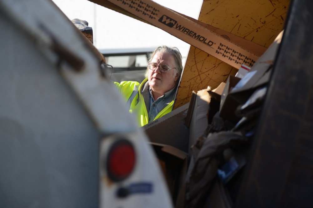 Russ Pert pushes a cardboard container to his truck for loading at the Como Recycling Facility in Minneapolis on Friday, Feb. 3, 2017.