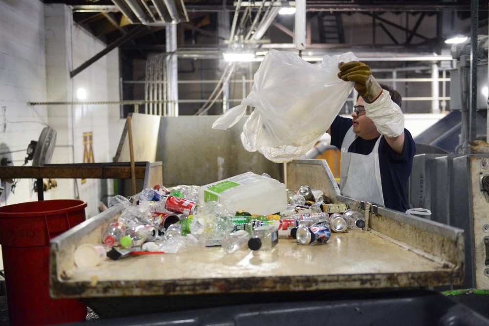 Dan Krieger unloads a bag of bottles for sorting at the Como Recycling Facility in Minneapolis on Friday, Feb. 3, 2017.