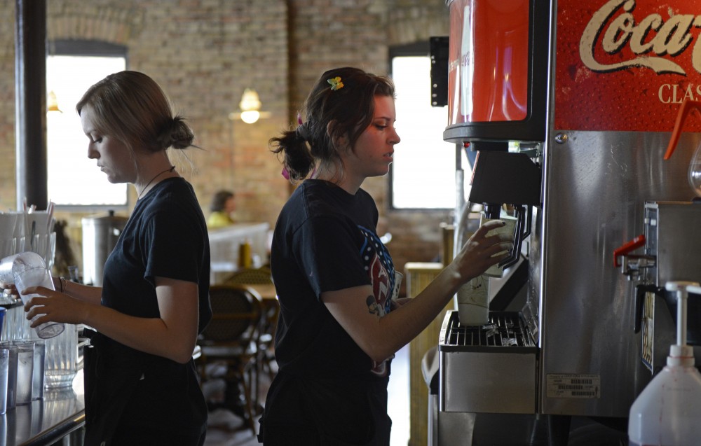 Andrea Fenno, left, and Maddie Limond, right, prepare drinks for guests at Annies Parlour on Monday, February 27, 2017 in Dinkytown. University businesses are looking to prepare for $15 minimum wage. 