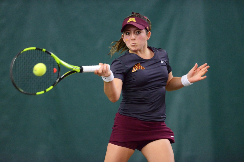 Sophomore Camila Vargas Gomez looks to return the ball at Baseline Tennis Center on Saturday, Mar. 4, 2017. The Gophers played against the University of Wisconsin.