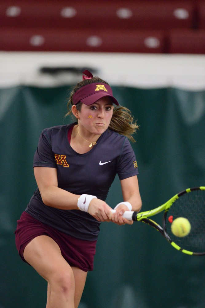 Sophomore Camila Vargas Gomez looks to return the ball at Baseline Tennis Center on Saturday, Mar. 4, 2017. The Gophers played against the University of Wisconsin.