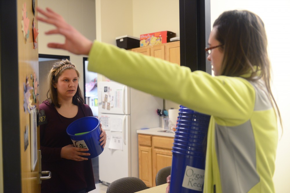 Environmental science and management sophomore Claudia Althoen explains the Minnesota Student Associations organics initiative to student Paige Adams in Yudof Hall on Friday, March 10, 2017.