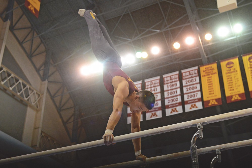 Freshman Justin Karstadt competes on the parallel bars at the Sports Pavilion on Feb. 13, 2016. 