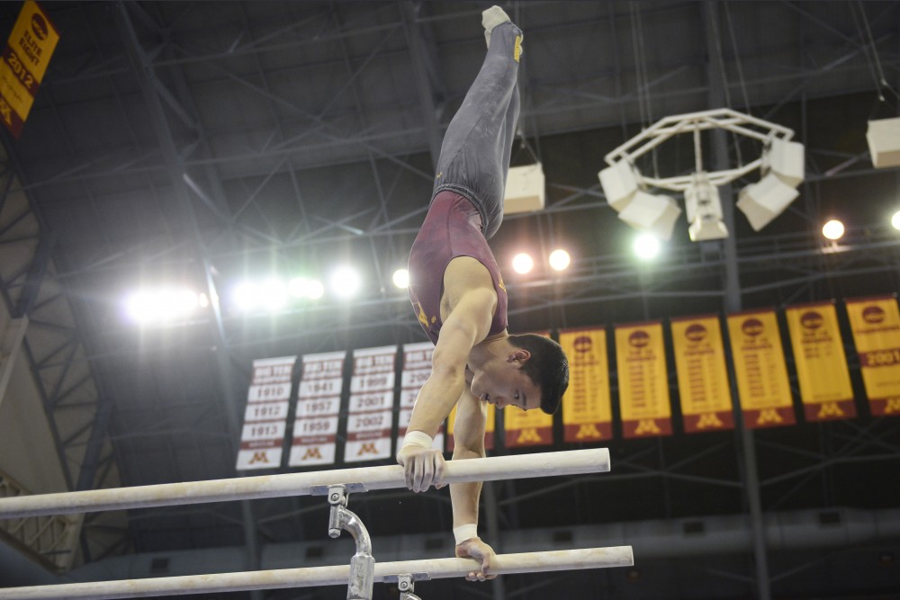 Justin Karstadt competes on the parallel bars against Penn State at the Sports Pavilion on Jan. 23, 2016. 