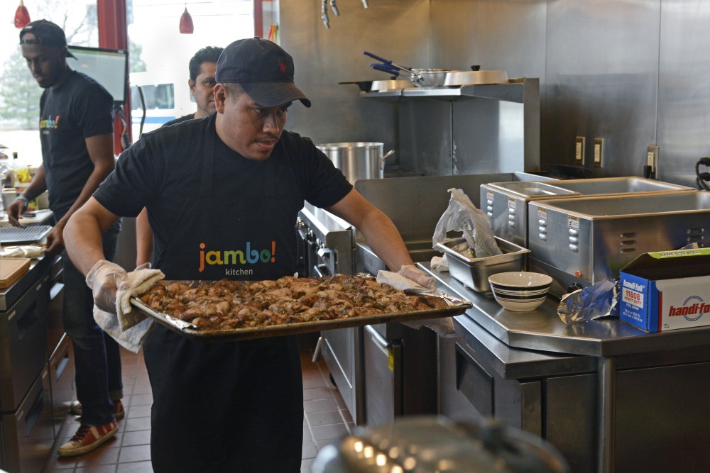 Kitchen staffer Francisco Flores prepares chicken for tacos at Jambo! Kitchen on April 5, 2017 on West Bank in Minneapolis. Jambo! opened in the space previously occupied by Afro Deli.