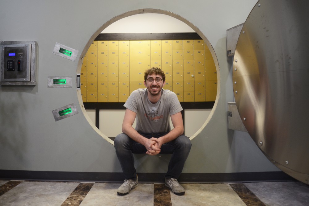 Mechanical engineering student Kenny Hubbell poses in an escape room he constructed at Puzzleworks on Wednesday, April 12, 2017 in St. Paul.