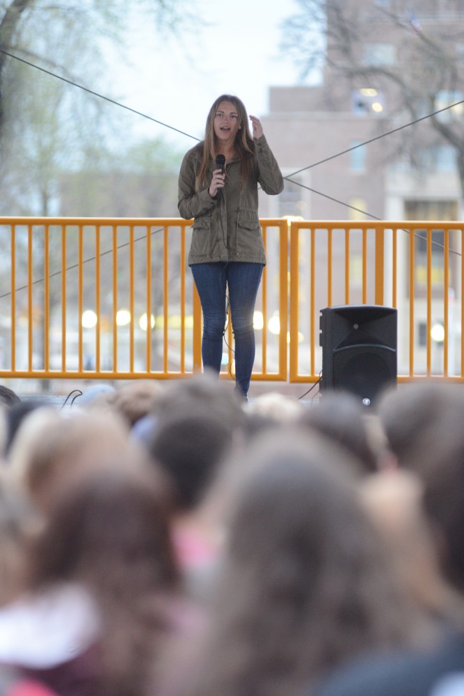 Sexual assault survivor Abby Honold speaks Tuesday on East Bank. Members of Greek life held their 4th annual Walk a Mile in Her Shoes event to make a stance against sexual assault.